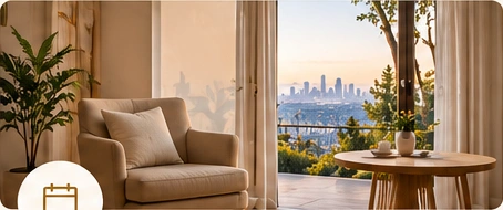 A comfortable armchair beside a window with skyline views